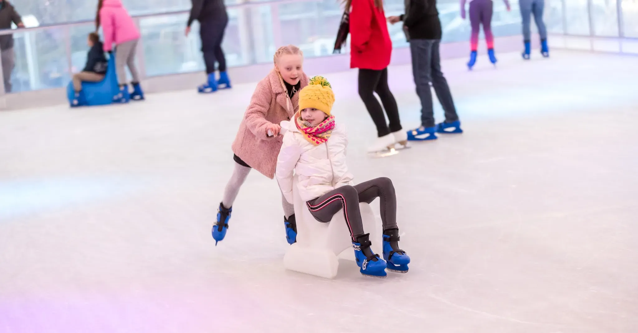 Two friends helping each other along the ice in Corby