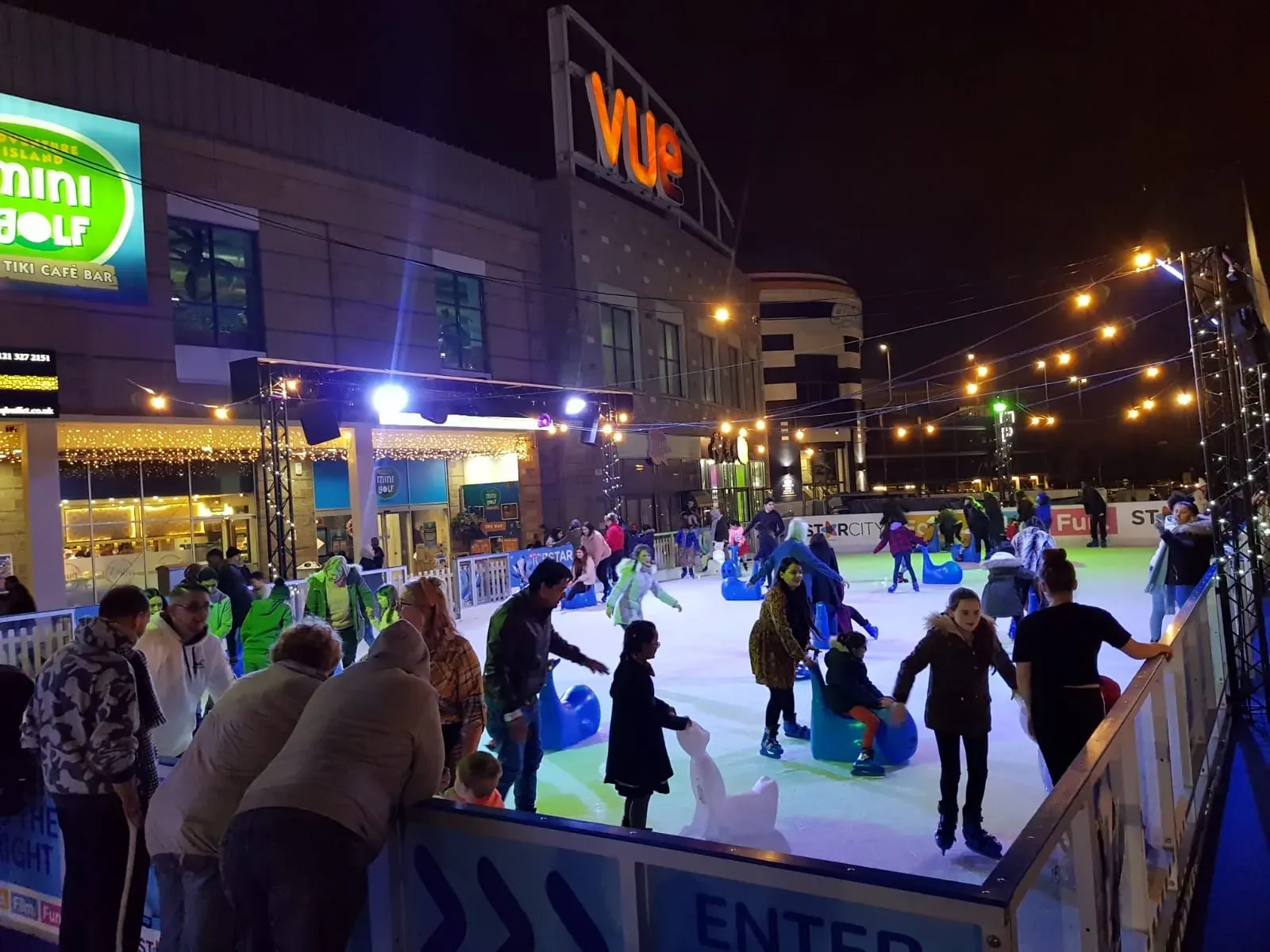 Skaters on the StarCity outdoor rink in the evening