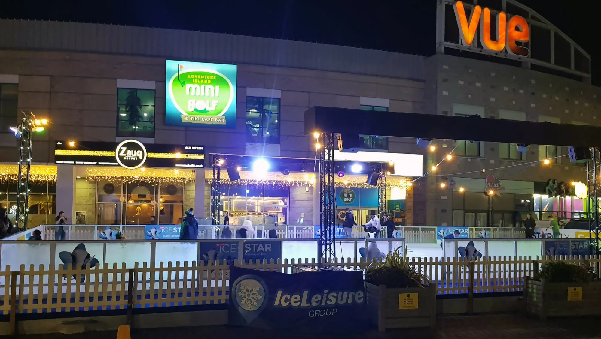 The StarCity rink at night beside the cinema