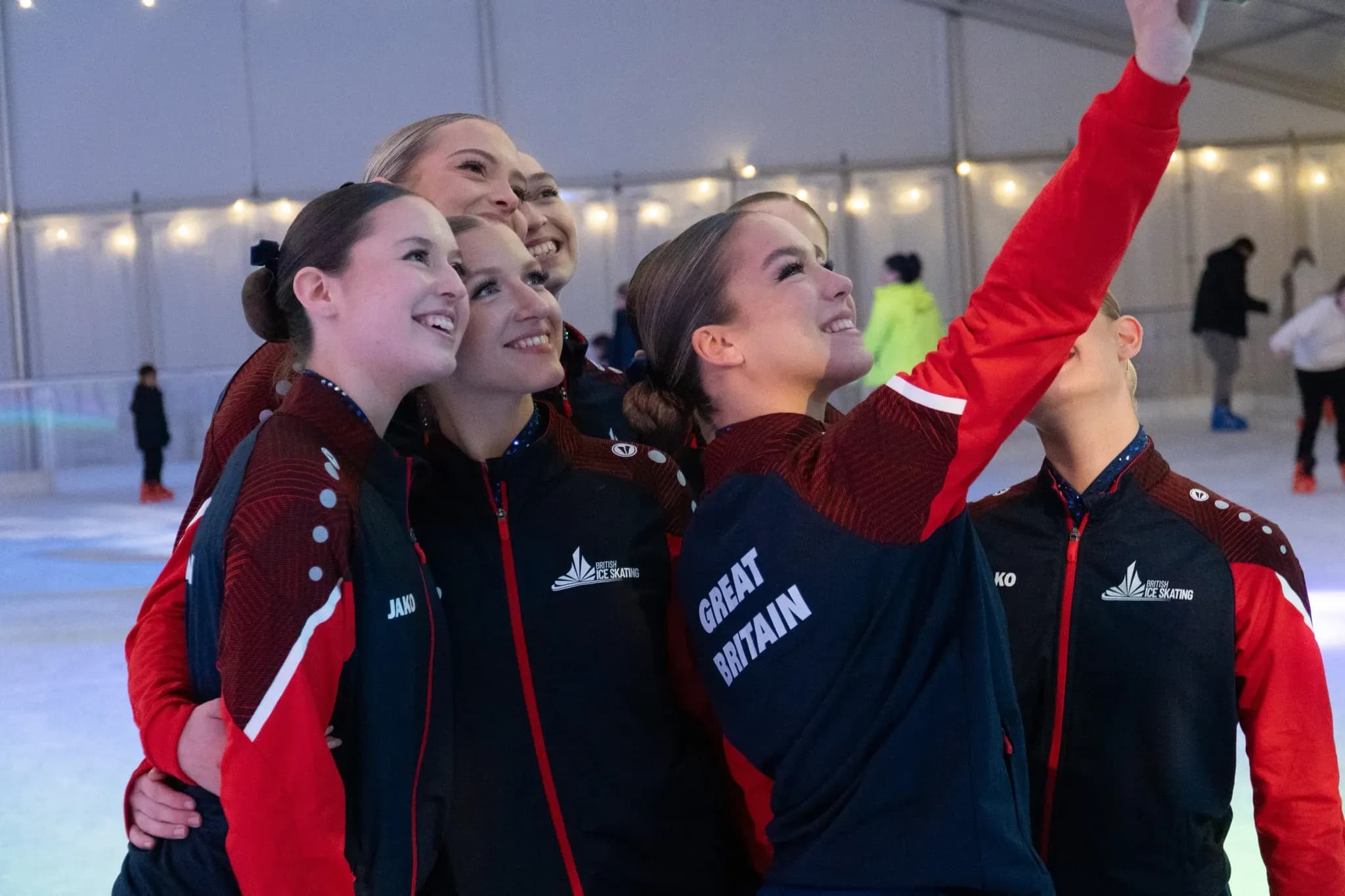 Great Britain synchronised skaters taking a selfie on the ice