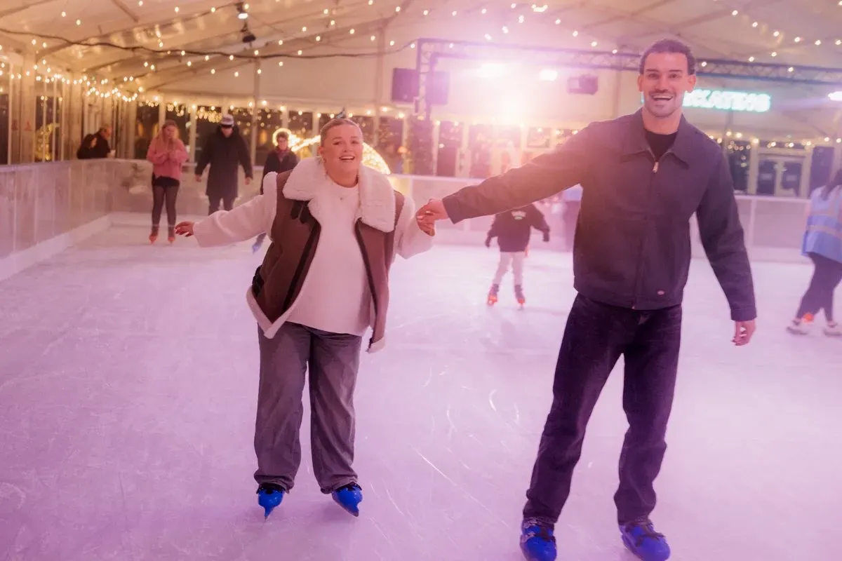 A couple skating hand in hand at Willen On Ice