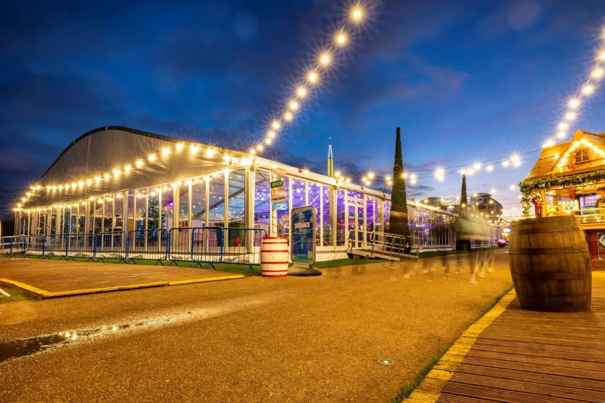 The Willen On Ice marquee under festoon lights at dusk